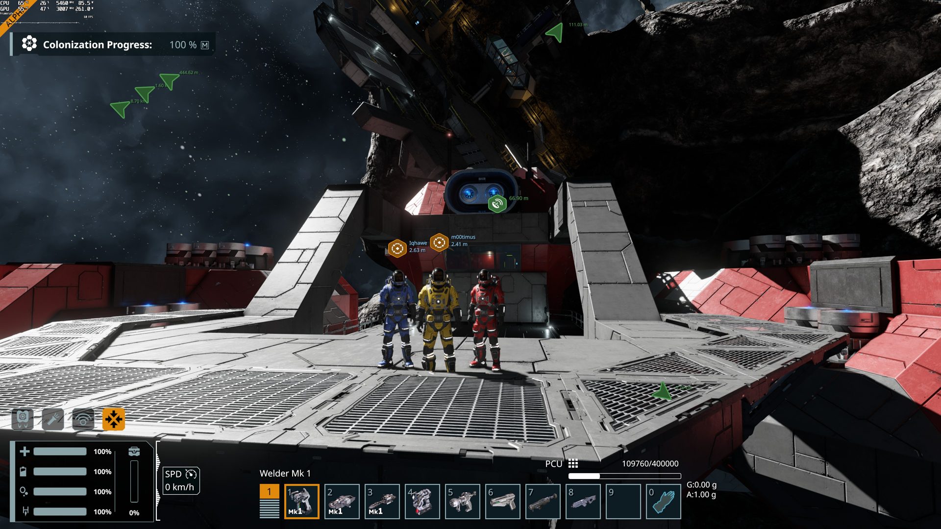 Three players in blue, yellow and red suits standing together on a space station, with name tags over their heads.